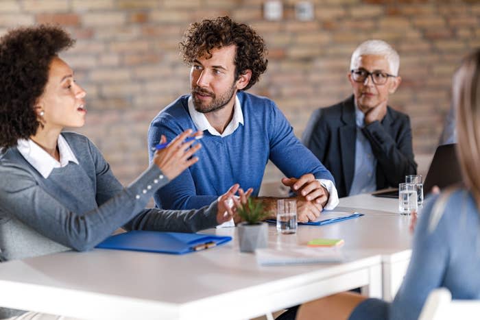 entrepreneur talking to his colleague during a business meeting in the office