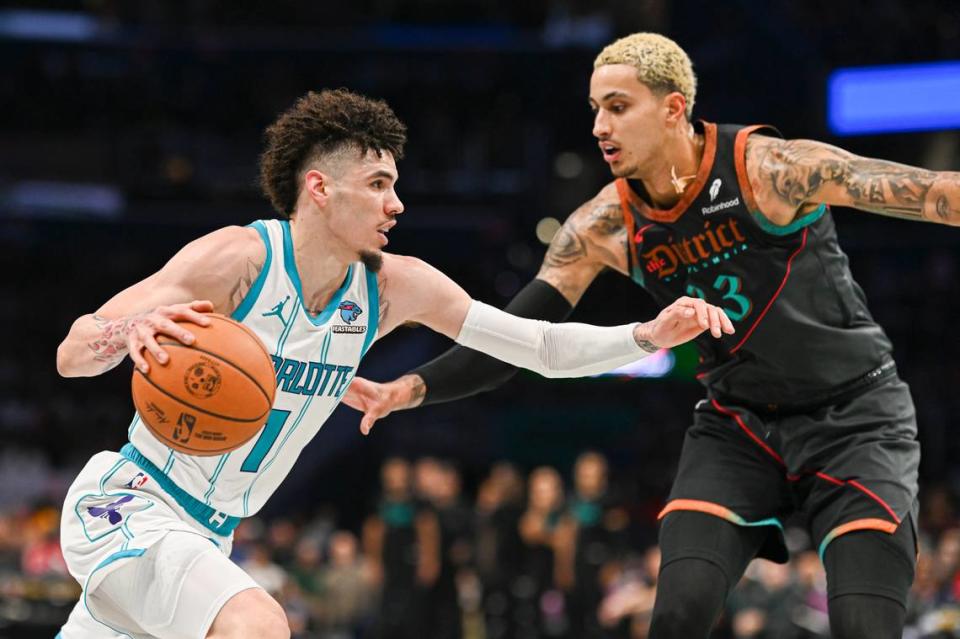 Charlotte Hornets guard LaMelo Ball (1) makes a move to the basket on Washington Wizards forward Kyle Kuzma (33) during the second half at Capital One Arena.