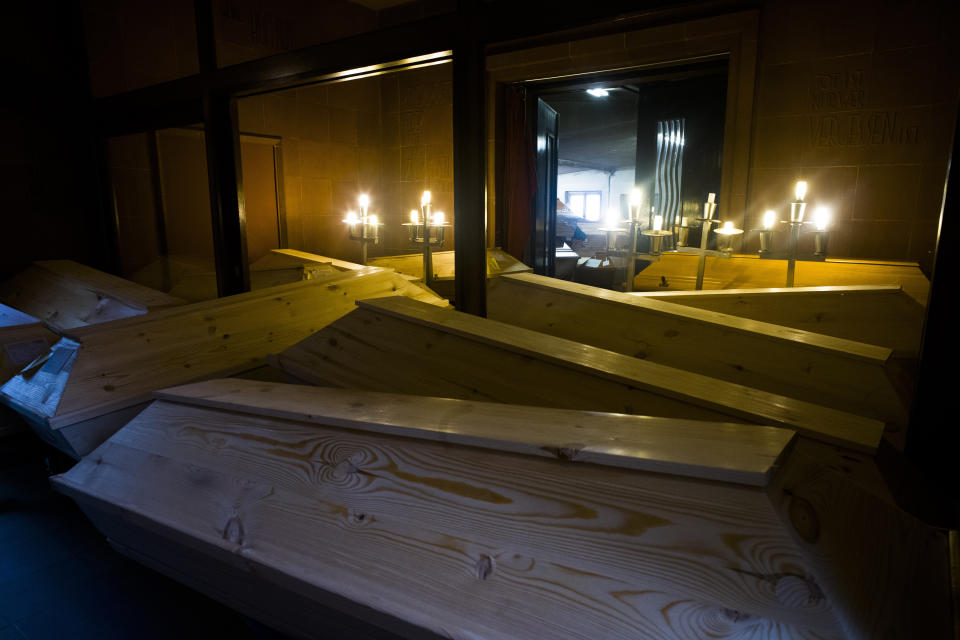 FILE - Coffins are stored in hallways of the crematorium in Meissen, Germany, Jan. 11, 2021. The crematorium would typically have 70 to 100 caskets on site at this time of year, now it has 300 bodies waiting to be cremated and more are brought to the crematorium every day. Germany is set to mark 100,000 deaths from COVID-19 this week, passing a somber milestone that several of its neighbors crossed months ago but which some in Western Europe's most populous nation had hoped to avoid. (AP Photo/Markus Schreiber, File)