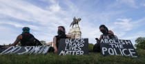 FILE - This June 2, 2020, file photo shows a part of a large group of protesters around the statue of Confederate General Robert E. Lee on Monument Avenue in Richmond, Va. The towering statue will be removed “as soon as possible” Virginia Gov. Ralph Northam said Thursday, June 4. (AP Photo/Steve Helber, File)