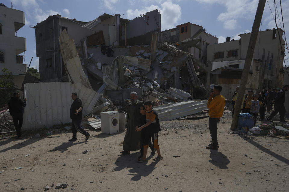 Palestinians inspect the rubble of destroyed building that the Israeli military said targeted the house of an Islamic Jihad member in Zeitoun neighborhood in Gaza City, Saturday, May 13, 2023. (AP Photo/Adel Hana)
