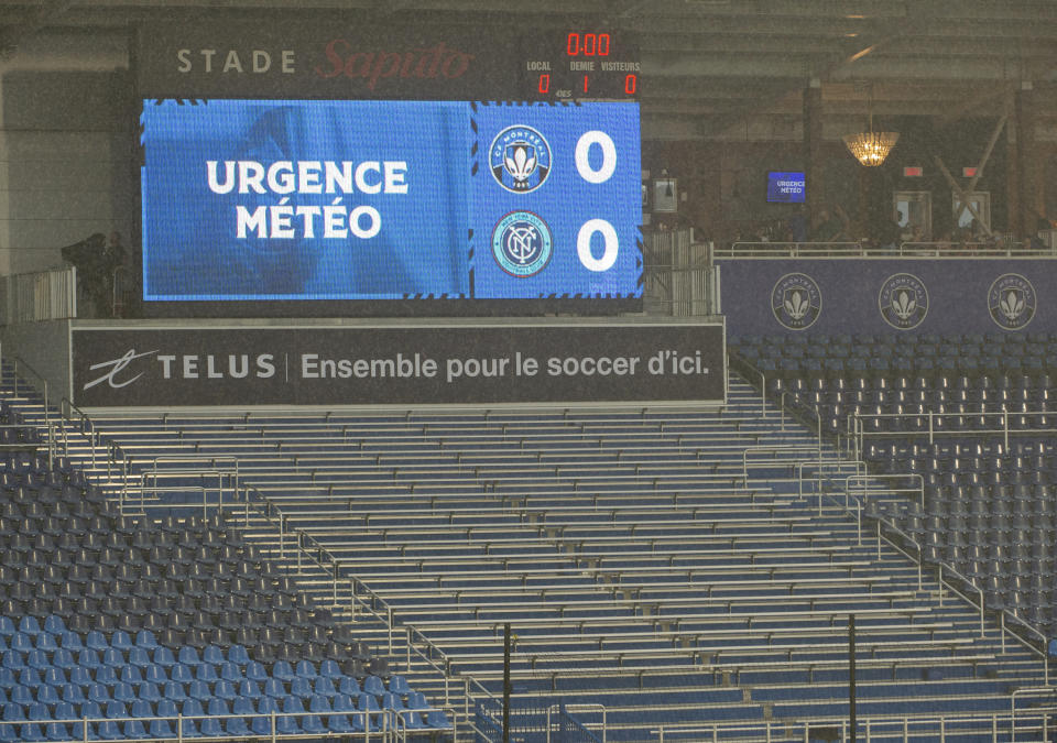 A sign reading in French "weather emergency" is shown as heavy rain and lightning delay an MLS soccer match between CF Montreal and New York City FC in Montreal, Saturday, July 1, 2023. (Peter McCabe/The Canadian Press via AP)