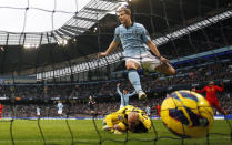 Manchester City's Edin Dzeko (top) celebrates after scoring during their English Premier League soccer match against Liverpool at the Etihad Stadium in Manchester, northern England February 3, 2013. REUTERS/Phil Noble (BRITAIN - Tags: SPORT SOCCER TPX IMAGES OF THE DAY) FOR EDITORIAL USE ONLY. NOT FOR SALE FOR MARKETING OR ADVERTISING CAMPAIGNS. NO USE WITH UNAUTHORIZED AUDIO, VIDEO, DATA, FIXTURE LISTS, CLUB/LEAGUE LOGOS OR "LIVE" SERVICES. ONLINE IN-MATCH USE LIMITED TO 45 IMAGES, NO VIDEO EMULATION. NO USE IN BETTING, GAMES OR SINGLE CLUB/LEAGUE/PLAYER PUBLICATIONS - RTR3DAZR