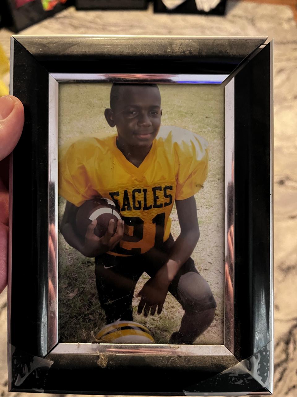 A photo of MJ Daniels, a Southern Miss player who was shot and killed on June 11, 2024, playing football as a kid.