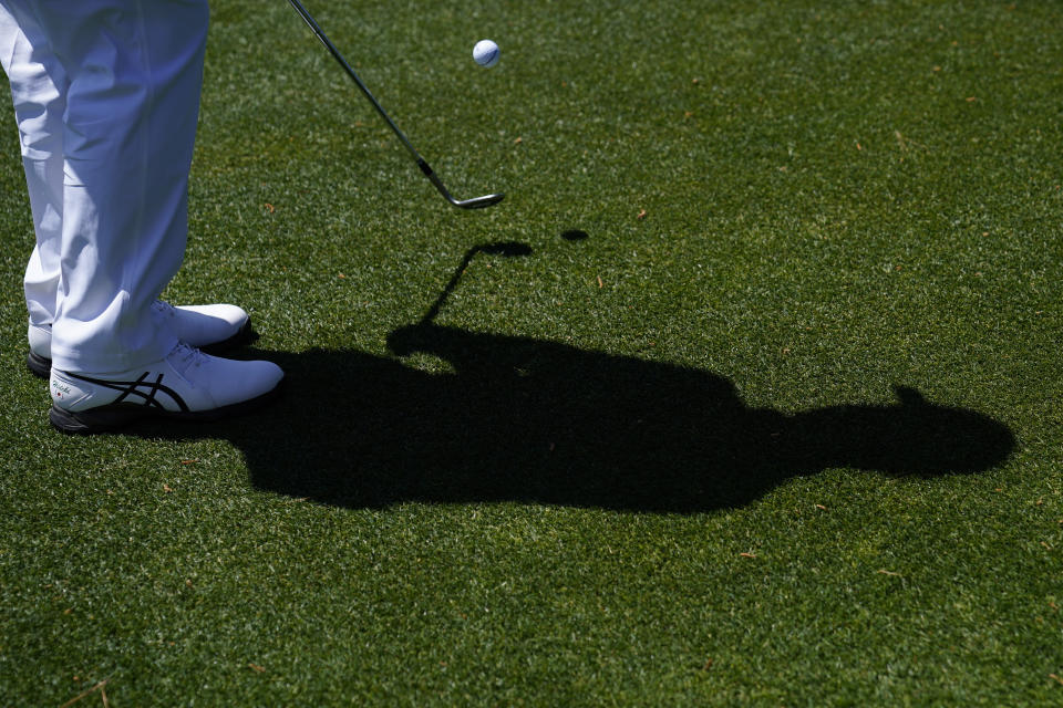 Hideki Matsuyama, of Japan, hits to the green on the 15th hole during a practice round for the Masters golf tournament on Monday, April 4, 2022, in Augusta, Ga. (AP Photo/Jae C. Hong)