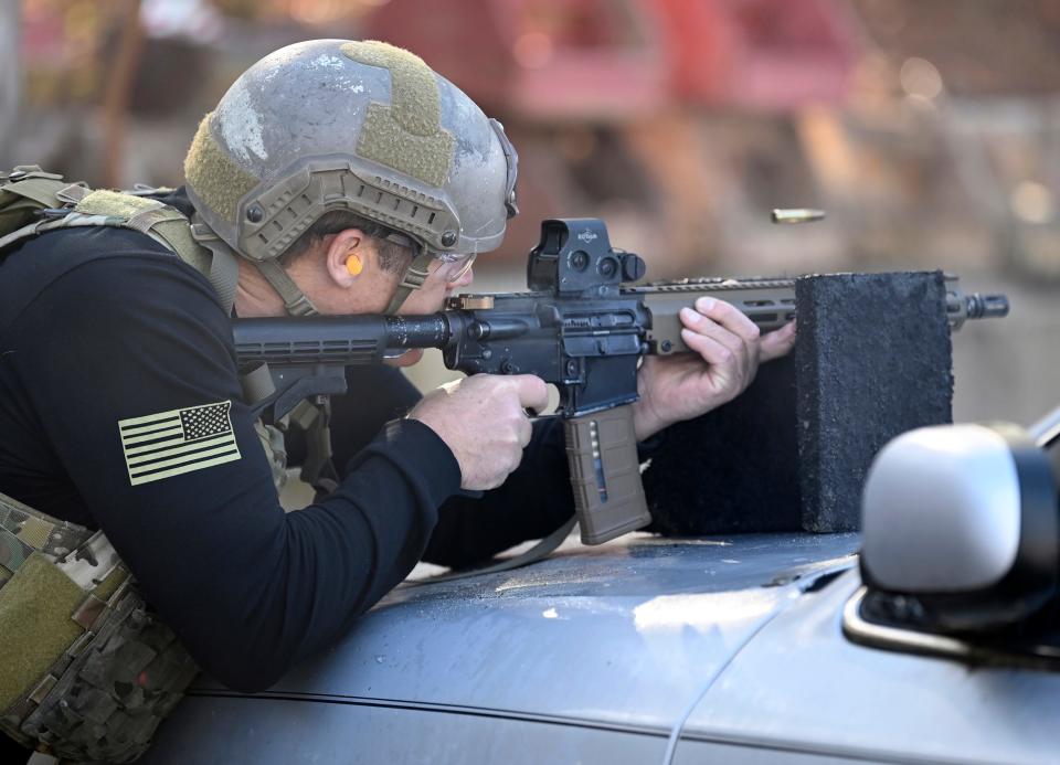 Actor Mark Valley fires an M4 Carbine during the 2021 Tactical Challenge at the Miller Training Complex of the U.S. Army John F. Kennedy Special Warfare Center and School  on Dec. 16, 2021. Twelve celebrities teamed up with Green Berets to take part in the annual event.