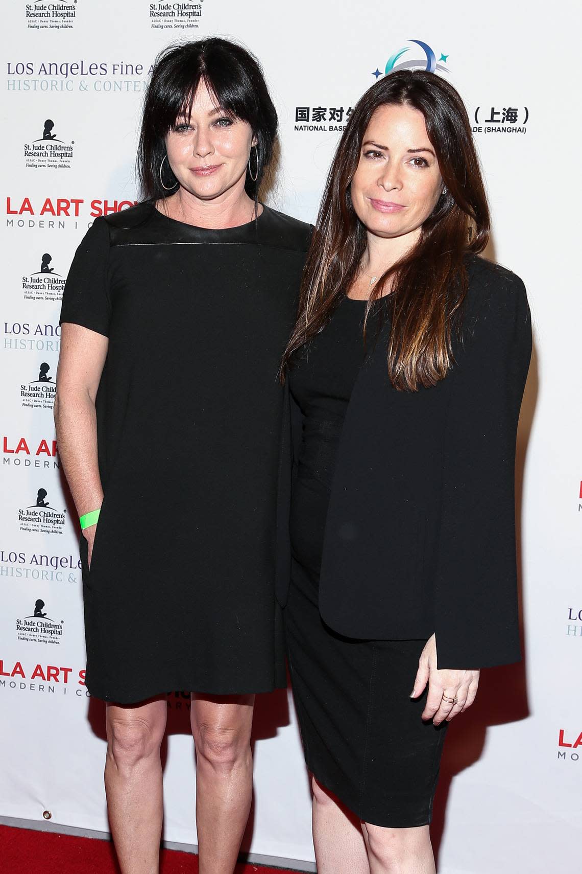 Shannen Doherty, left, and Holly Marie Combs, shown in 2016, were two of the three Halliwell sisters in the WB TV series “Charmed.” Alyssa Milano was the third sister.