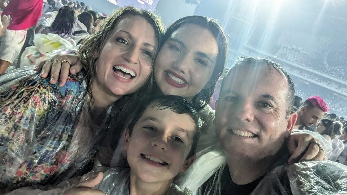 The McMahons take a photo in the rain at the Sunday night Eras Tour show in Rio de Janeiro, Brazil.
