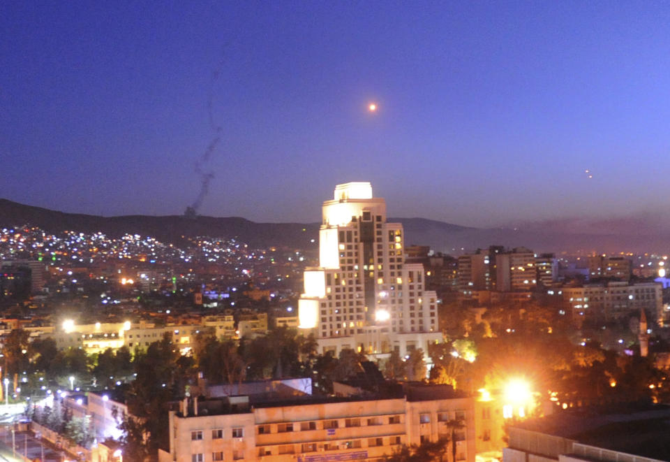 <p>This photo released by the Syrian official news agency SANA, shows smoke, rising after U.S.-led airstrikes targeting different parts of the Syrian capital Damascus in retaliation for the country’s alleged use of chemical weapons early Saturday, April 14, 2018. (Photo: SANA via AP) </p>