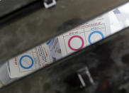 Ballots on constitutional amendments inside a ballot box on the second day of the three-day voting at a polling station in Cairo, Egypt, Sunday, April 21, 2019. Egyptians are voting on constitutional amendments that would allow el-Sissi to stay in power until 2030. Arabic reads, "Agree, in blue, disagree in red". (AP Photo/Amr Nabil)