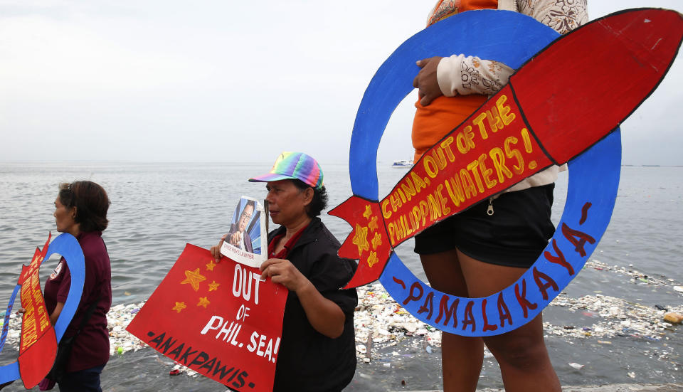 FILE - In this June 14, 2018, file photo, demonstrators continue to protest China over its coast guards' seizure of fish caught by Filipino fishermen near the contested Scarborough Shoal in the South China Sea by the baywalk in Manila, Philippines. The Philippine government filed a diplomatic protest after Chinese forces seized fishing equipment set up by Filipinos in a disputed shoal in their latest territorial spat in the South China Sea. The Department of Foreign Affairs in Manila said in a statement Thursday night, Aug. 20, 2020 that the Philippines “also resolutely objected" to China continuing to issue radio challenges to Philippine aircraft patrolling over the disputed waters. (AP Photo/Bullit Marquez, File)