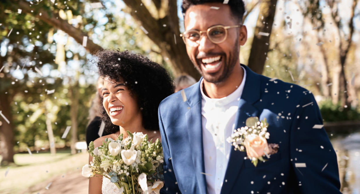 Bride and groom smiling at their wedding guest