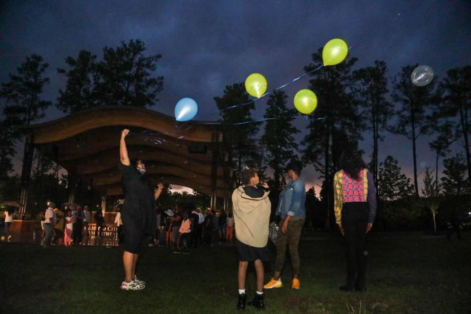 Friends and family of Sanaa Amenhotep release balloons in her memory at Doko Meadows in Blythewood.