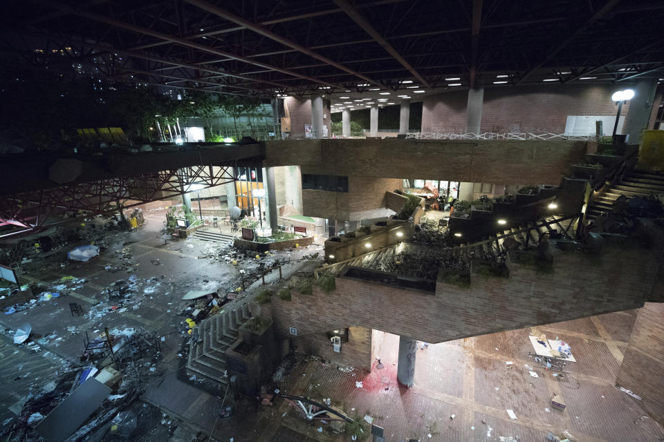 This Friday, Nov. 22, 2019, photo, show debris at the entrance of the Hong Kong Polytechnic University campus in Hong Kong. Most of the protesters who took over the university have left following clashes with police, but an unknown number have remained inside, hoping somehow to avoid arrest. (AP Photo/Vincent Thian)