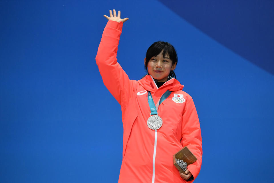 Japan's silver medallist Miho Takagi waves on the podium during the medal ceremony for the speed skating women's 1500m on Feb. 13, 2018. | Kirill Kudryavtsev—AFP/Getty Images: