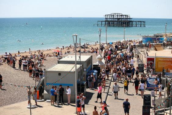 People queue for the toilet on Brighton Beach on 30 May (Bryn Lennon/Getty Images)