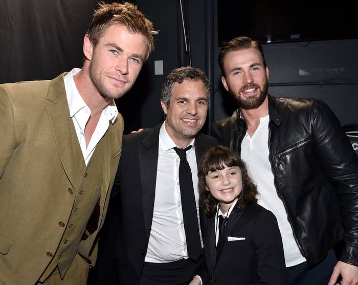 Mark poses with Bella as a little girl, while standing next to Chris Hemsworth and Chris Evans