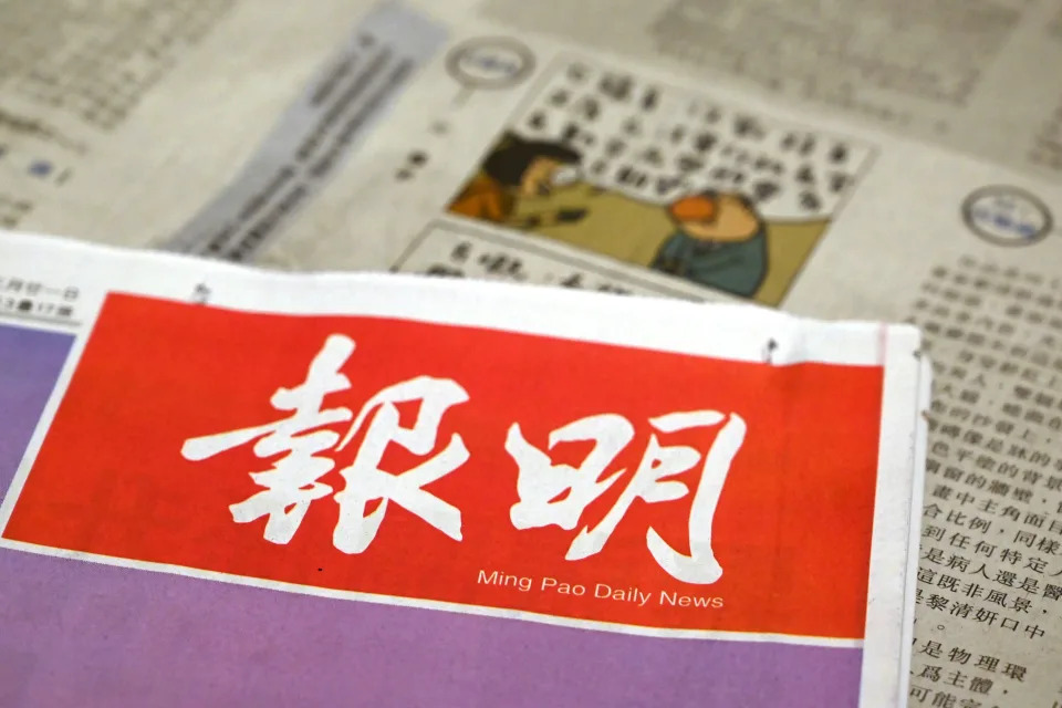 A photo illustration shows the front page of the Ming Pao News and a cartoon by cartoonist Wong Kei-kwan, who uses the nom de plume 