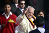 Pope Francis waves at the crowd as he arrives at the Mariscal Sucre international airport in Quito on July 5, 2015