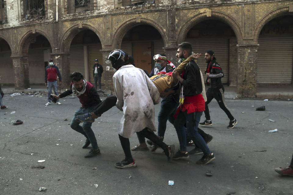 An injured protester is rushed to a hospital during clashes between security forces and anti-government demonstrators in Baghdad, Iraq, Nov. 22, 2019. (Photo: Hadi Mizban/AP)