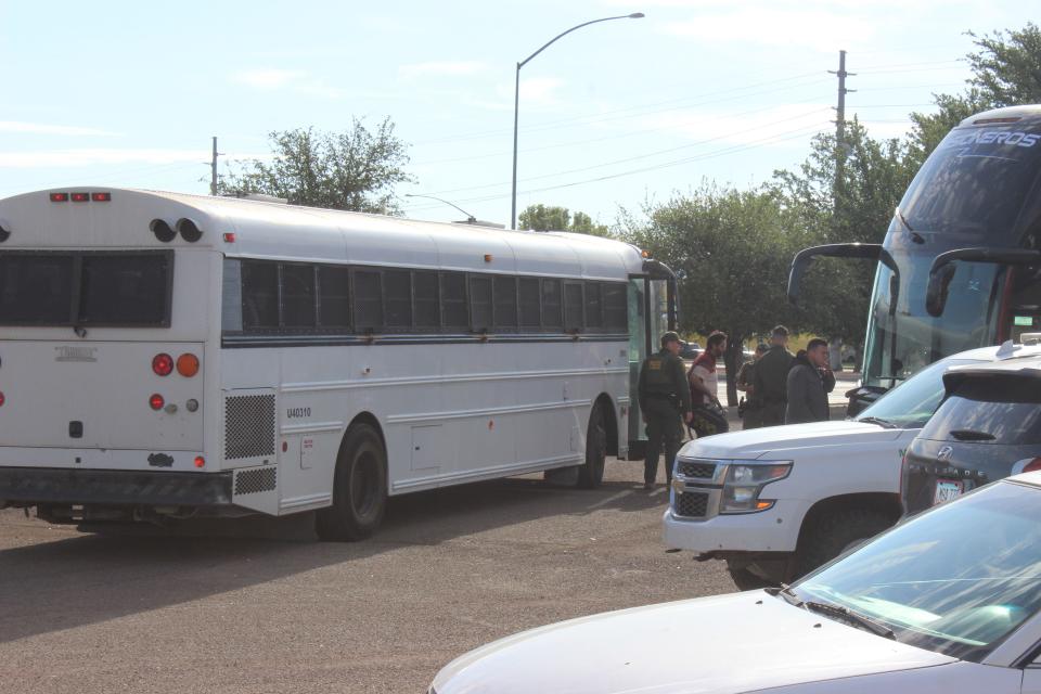 U.S. Border Patrol transfers a few dozen migrants to a state-run charter bus headed toward Phoenix from the Douglas Visitor's Center parking lot on Wednesday, May 17, 2023.