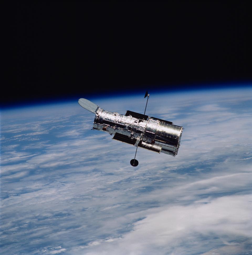 the hubble space telescope in orbit above Earth