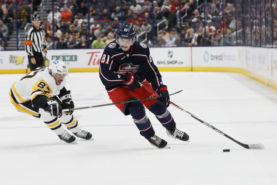 Columbus Blue Jackets' Stanislav Svozil, right, carries the puck past Pittsburgh Penguins' Sidney Crosby during the second period of an NHL hockey game Thursday, April 13, 2023, in Columbus, Ohio. (AP Photo/Jay LaPrete)