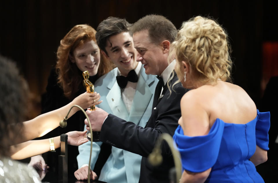Brendan Fraser, center, winner of the award for best performance by an actor in a leading role for "The Whale", gets his statuette engraved at the Governors Ball after the Oscars on Sunday, March 12, 2023, at the Dolby Theatre in Los Angeles. Holden Fletcher Fraser, from left, Leland Francis Fraser, and Jeanne Moore, far right, look on.(AP Photo/John Locher)
