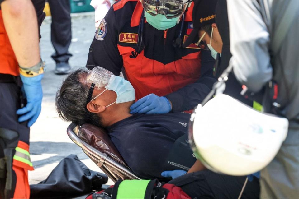 Emergency services treating a survivor (CNA/AFP via Getty Images)