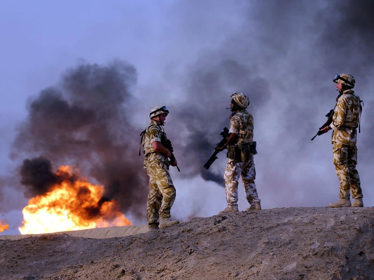 British troops from the 2nd Battalion Light Infantry carry out an evening patrol targeting oil smugglers at a plant in Rauallah, Southern Iraq (PA)