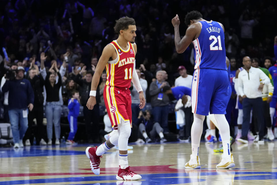 Atlanta Hawks' Trae Young, left, walks off the court after an NBA basketball game against the Philadelphia 76ers, Monday, Nov. 28, 2022, in Philadelphia. (AP Photo/Matt Slocum)