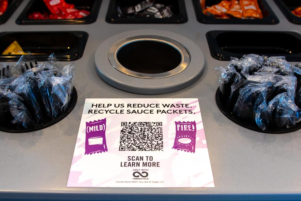 Taco Bell sauce packets, plastic utensils and the QR code for the recycling program
