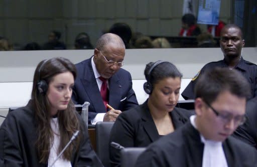 Former Liberian president Charles Taylor (rear C) waits for the start of the judgement hearing April 26, at the Special Court for Sierra Leone, in Leidschendam outside The Hague. Nations, rights groups and victims hailed a historic verdict after Taylor was convicted Thursday of aiding and abetting war crimes in Sierra Leone