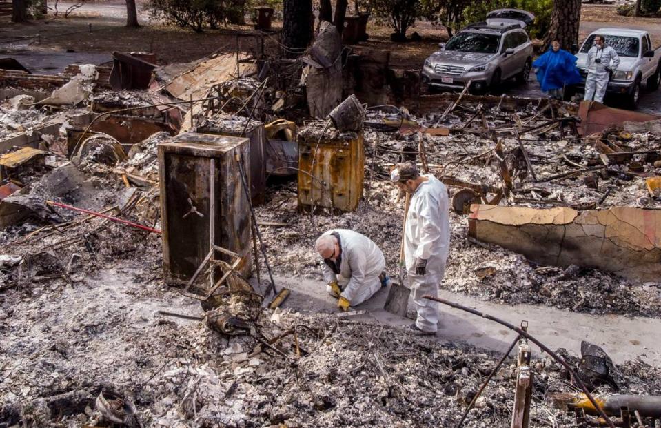 Lou Donnelly, left, of Paradise works on the rubble of his home after the Camp Fire with his brother-in-law Donald Weeks, of San Diego, in 2018. Wildfires, fueled by climate change have leveled towns like Paradise, and costs to rebuild has skyrocketed. These and other factors have insurers making moves to rein in risks.