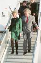 <p>While flying on the tycoon's Airbus 340—called "The Lady in Red"—Princess Diana looked stunning in a green suit with gold buttons. Richard Branson, meanwhile, chose a gray suit and red tie for the occasion. </p>