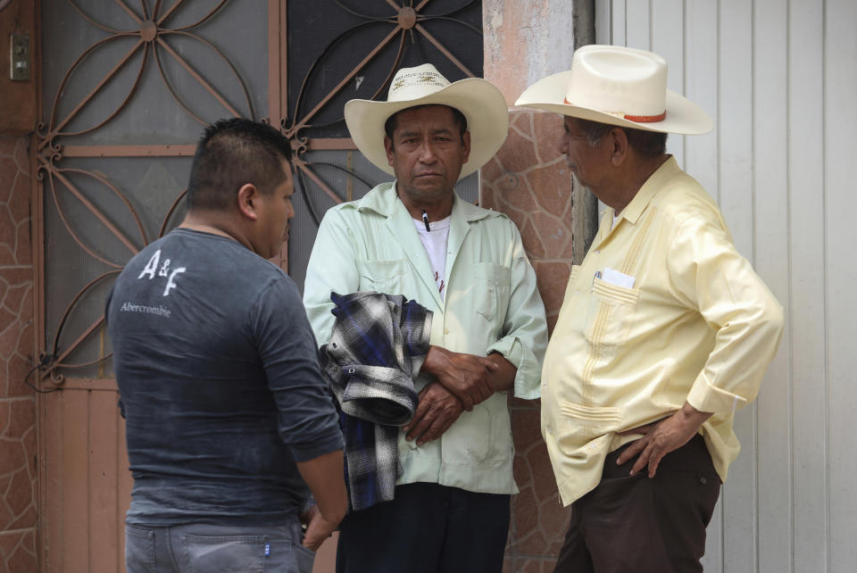 Family members of slain mayor of Mixtla de Altamirano, Maricela Vallejo, and her husband, stand near the forensics office where their bodies were taken in Orizaba, Veracruz, Mexico, Thursday, April 25, 2019. Prosecutors said the couple and their driver came under fire from behind and both sides of their SUV while traveling on a highway. (AP Photo/Felix Marquez)