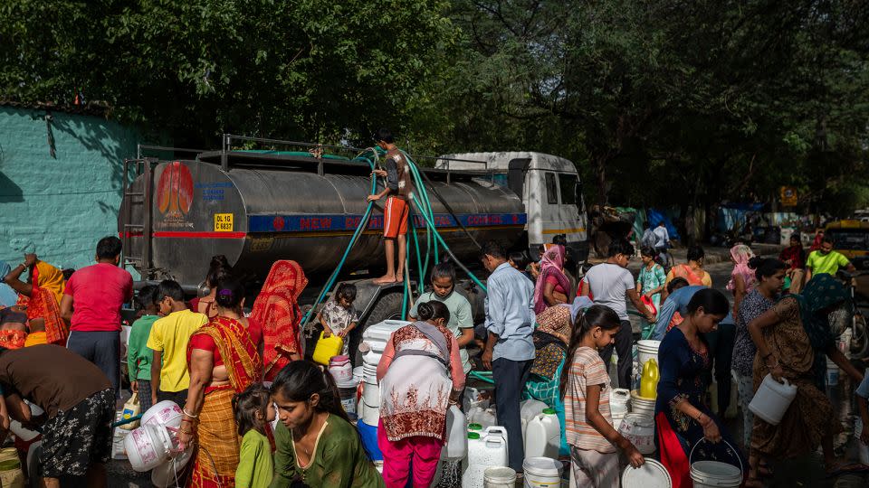 Residents fill water from a water tanker at a slum in New Delhi, India, on Friday, May 19, 2023. - Anindito Mukherjee/Bloomberg/Getty Images