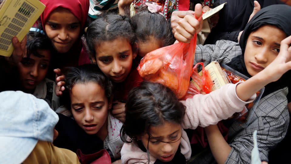 Children receive free meals provided by a charitable kitchen in the Mseek area on March 23, 2022 in Sanaa. The civil war in Yemen has left 17 million people facing food insecurity, according to the World Food Programme. - Mohammed Hamoud/Getty Images