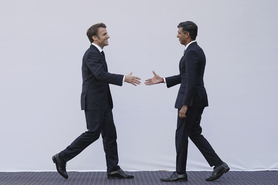 FILE - Britain's Prime Minister Rishi Sunak right, reaches to shake hands with President of France Emmanuel Macron ahead of a bilateral meeting during the COP27 summit, in Sharm el-Sheikh, Egypt, Nov. 7, 2022. (Stefan Rousseau/Pool Photo via AP, File)
