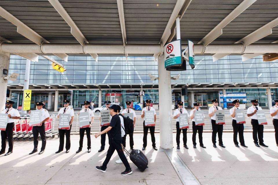 <p>Cole Burston / Bloomberg via Getty Images</p> Air Canada pilots picket at Toronto Pearson Airport in Toronto, Ontario, Canada, on Tuesday, Aug. 27, 2024.