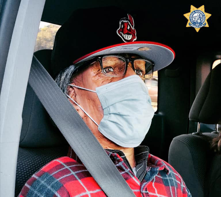 A dummy wearing a Cleveland Indians cap is seen seated in a car.