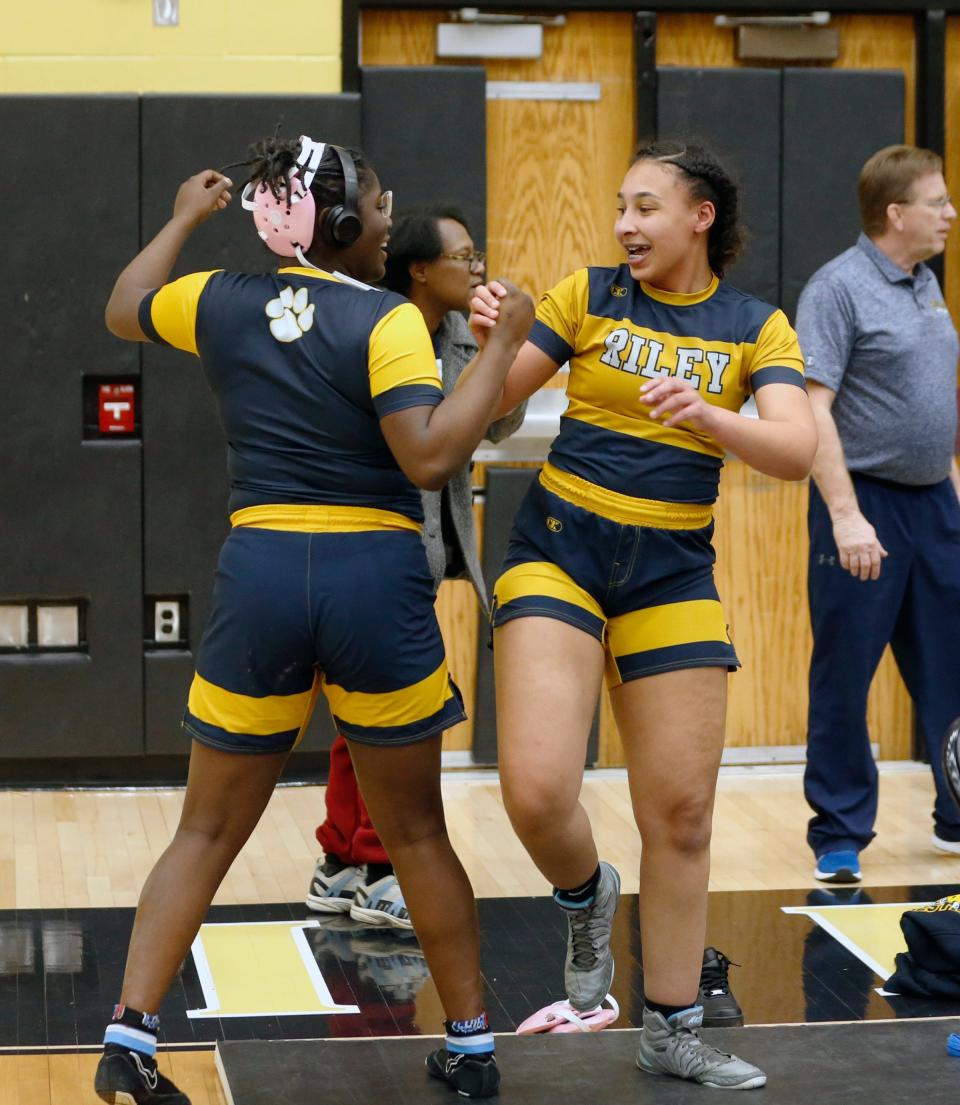 South Bend Riley juniors Janiya Howard, left, and Nyisha Gindelberger celebrate after Gindelberger won the 170-pound championship match at the IHSGW girls wrestling semistate Friday, Jan. 5, 2024, at Penn High School in Mishawaka.