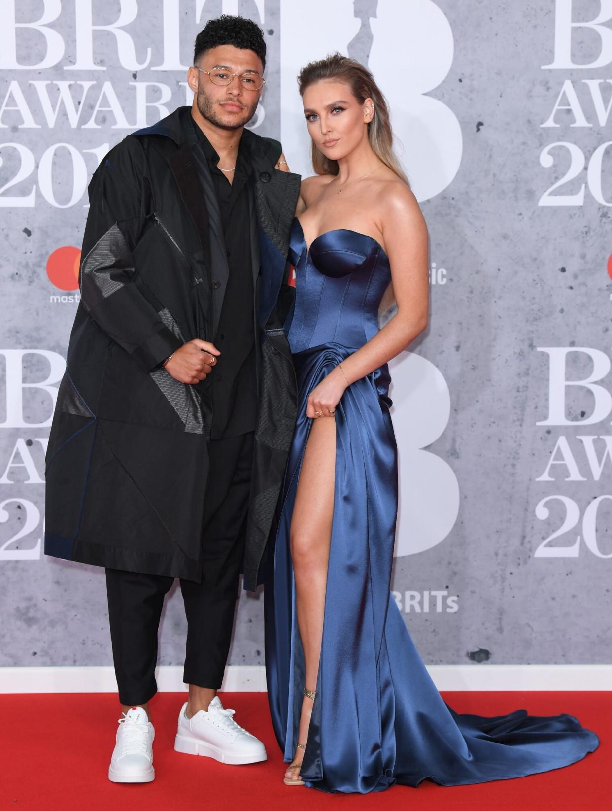 LONDON, ENGLAND - FEBRUARY 20: (EDITORIAL USE ONLY) Alex Oxlade-Chamberlain and Perrie Edwards attend The BRIT Awards 2019 held at The O2 Arena on February 20, 2019 in London, England. (Photo by Karwai Tang/WireImage)