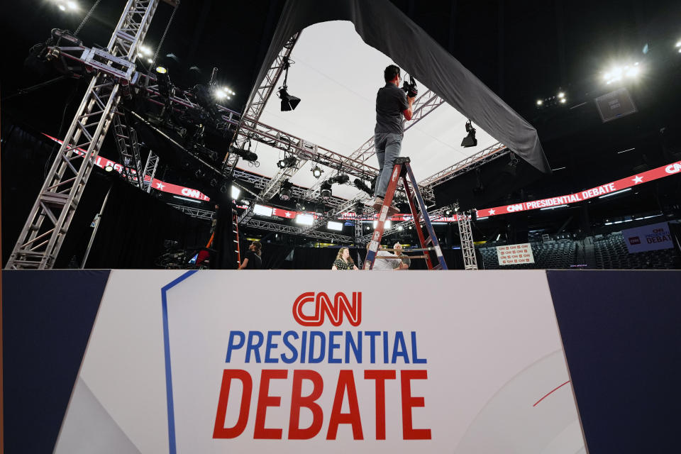 Ben Starett, lighting programmer for CNN, sets up lights in the spin room for the upcoming CNN Presidential Debate between President Joe Biden and Republican presidential candidate former President Donald Trump in Atlanta, Wednesday, June 26, 2024. (AP Photo/Gerald Herbert)