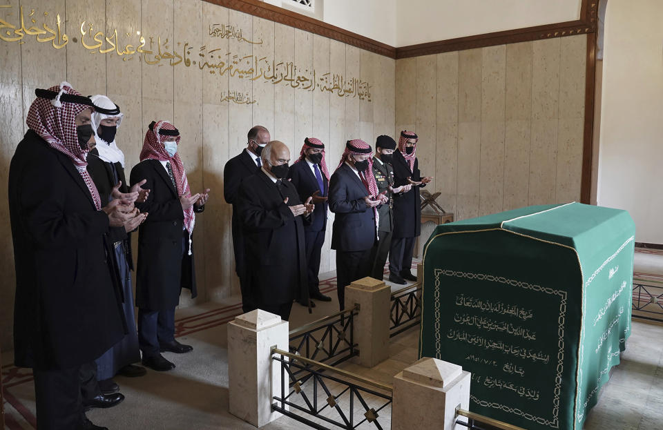 This photo from the Royal Court twitter account, shows Jordan’s King Abdullah II, third right, Prince Hassan bin Talal, fifth right, Prince Hamzah bin Al Hussein, seventh right, and others pray during a visit to the tomb of the late King Abdullah I, in Amman Jordan, Sunday, April 11, 2021. King Abdullah II and his half brother Prince Hamzah have made their first joint public appearance since a palace feud last week. Members of the Jordanian royal family Sunday marked the centenary of the establishment of the Emirate of Transjordan, a British protectorate that preceded the kingdom. (Royal Court Twitter Account via AP)