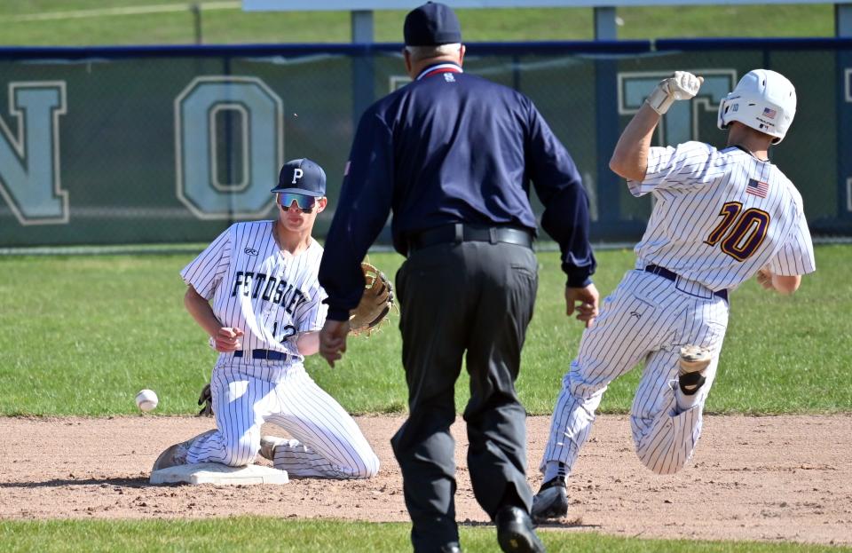 Petoskey's Peyton Harmon watches a throw from home into his glove to try to tag out a Greenville base runner on Saturday.