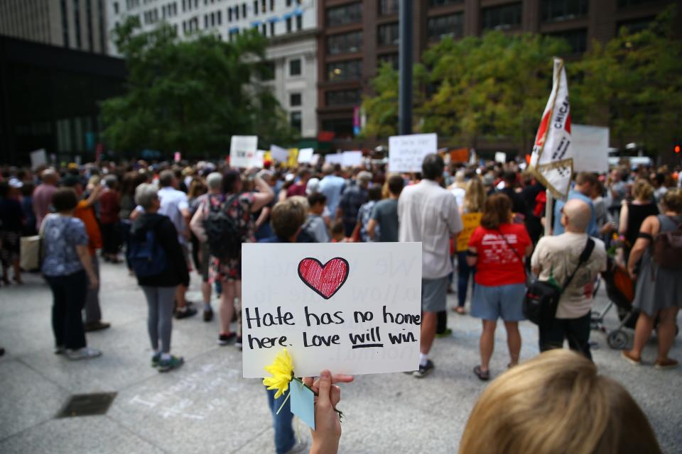 A demonstrator holds a banner reading "Hate Has No Home Here. Love Will Win" during an Aug. 13 protest at Federal Plaza Square in Chicago.