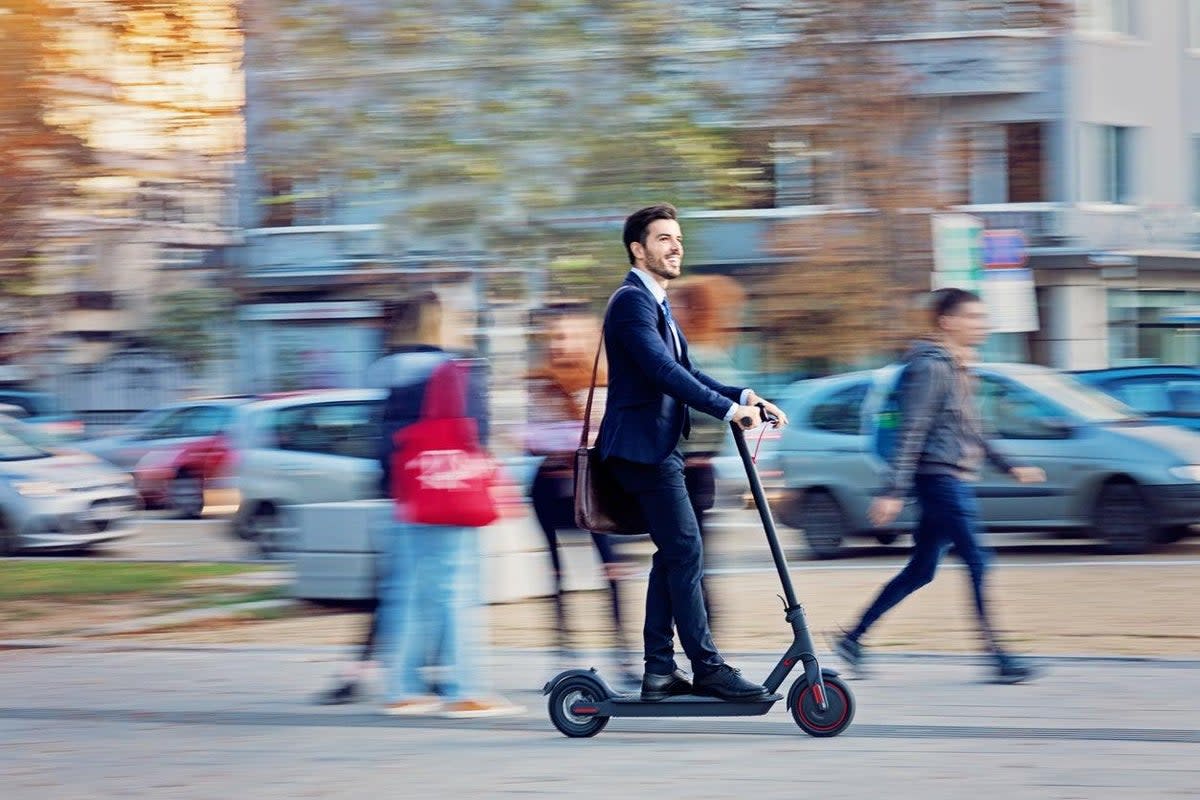 A businessman riding an e-scooter: but what if you can’t see him coming?   (Getty)