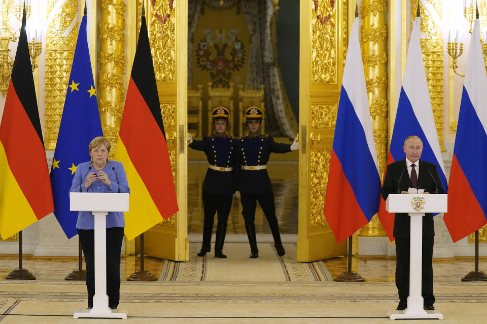 Russian President Vladimir Putin, right, and German Chancellor Angela Merkel attend a joint news conference following their talks in the Kremlin in Moscow, Russia, Friday, Aug. 20, 2021. The talks between Merkel and Putin are expected to focus on Afghanistan, the Ukrainian crisis and the situation in Belarus among other issues. (AP Photo/Alexander Zemlianichenko, Pool)