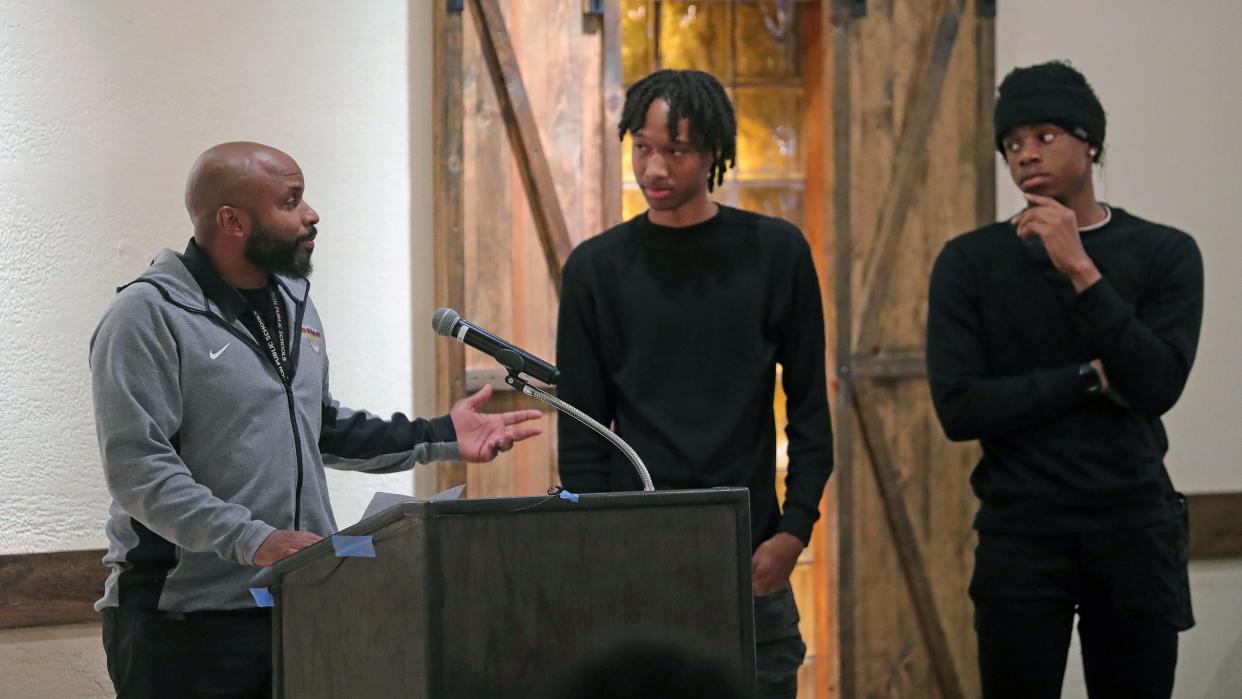 Garfield boys basketball coach McNeal Thompson introduces Elliott Jackson and Lamonte Brooks during the Akron City Series high school basketball media day at Guy's Party Center on Tuesday in Akron.